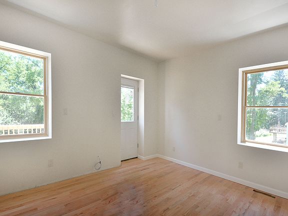 Master bedroom suite with deck and hardwood floors