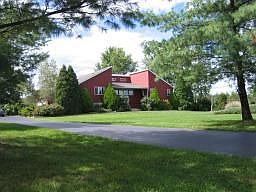 Beautifully landscaped home set back on 4.7 acres
