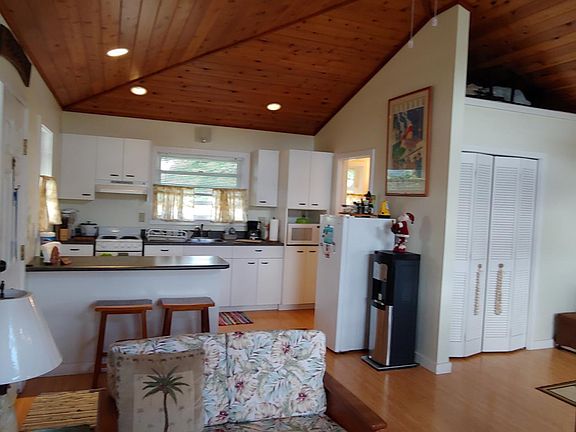 Cedar ceilings with can lights overlooking kitchen and closet area.