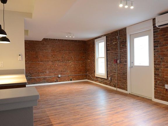 Open living space with exposed brick. (lots of character and charm)