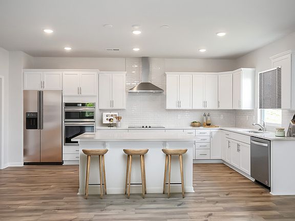 Large kitchen with premium countertops and modern soft close drawers.