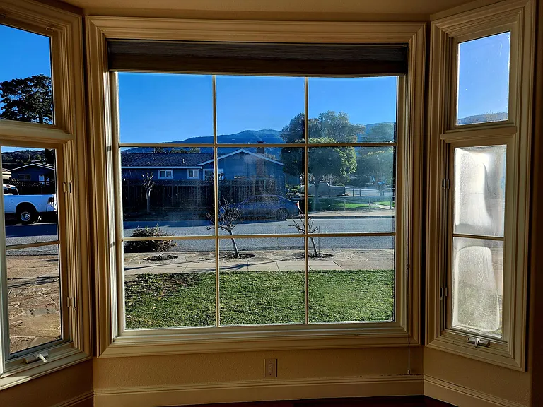 Family room bay view windows with view to front yard and Los Gatos Hills.