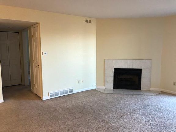 Another view of the living room, washer/dryer closet and connecting hallway to master bedroom and second bathroom on the left