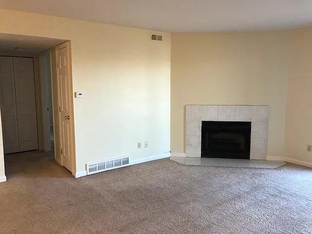 Another view of the living room, washer/dryer closet and connecting hallway to master bedroom and second bathroom on the left