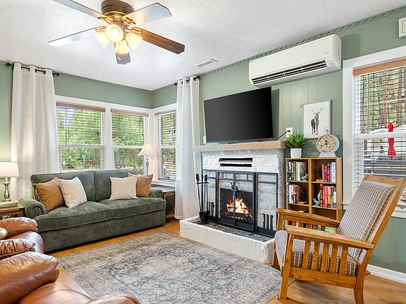 Cozy living space with 55" Smart TV, pull-out sofa, and gas fireplace.