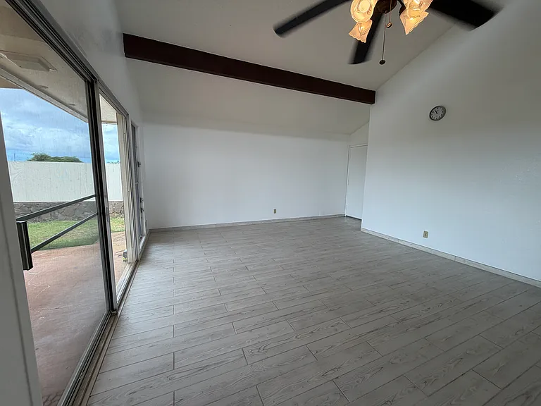 Living room view 3, see rock wall with fence on the side yard outside. Vaulted ceilings, spacious.