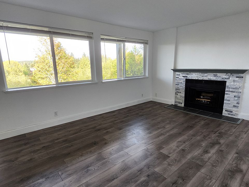 Living room with fireplace and view.
