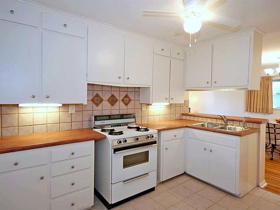 This great kitchen has new tile flooring and backsplash. 