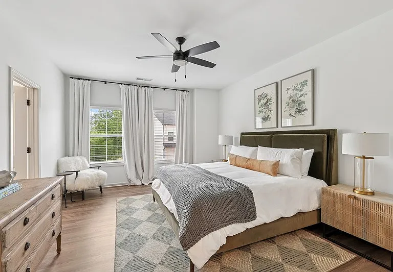 Primary Bedroom with king size bed and large window letting in nice natural light.