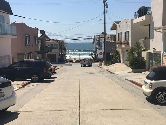 standing in street in front of duplex