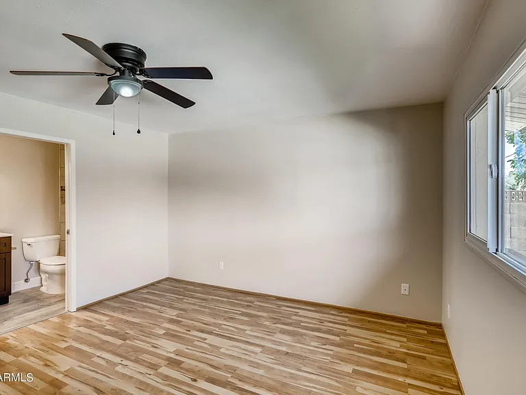 Large primary bedroom suite includes walk-in closet with built in shelves + an additional extra-large closet and private bathroom with tiled shower.