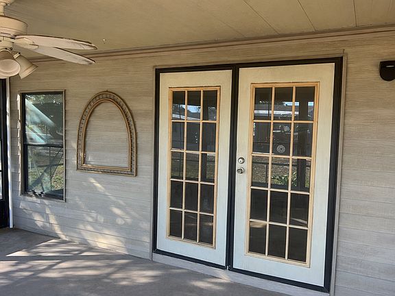 Screened-in porch showing French doors to interior.