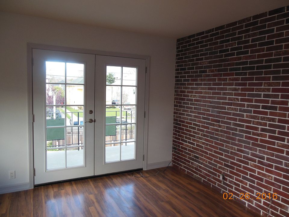 Living room with brick wall & french door