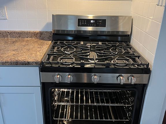 New SS self-cleaning gas stove.