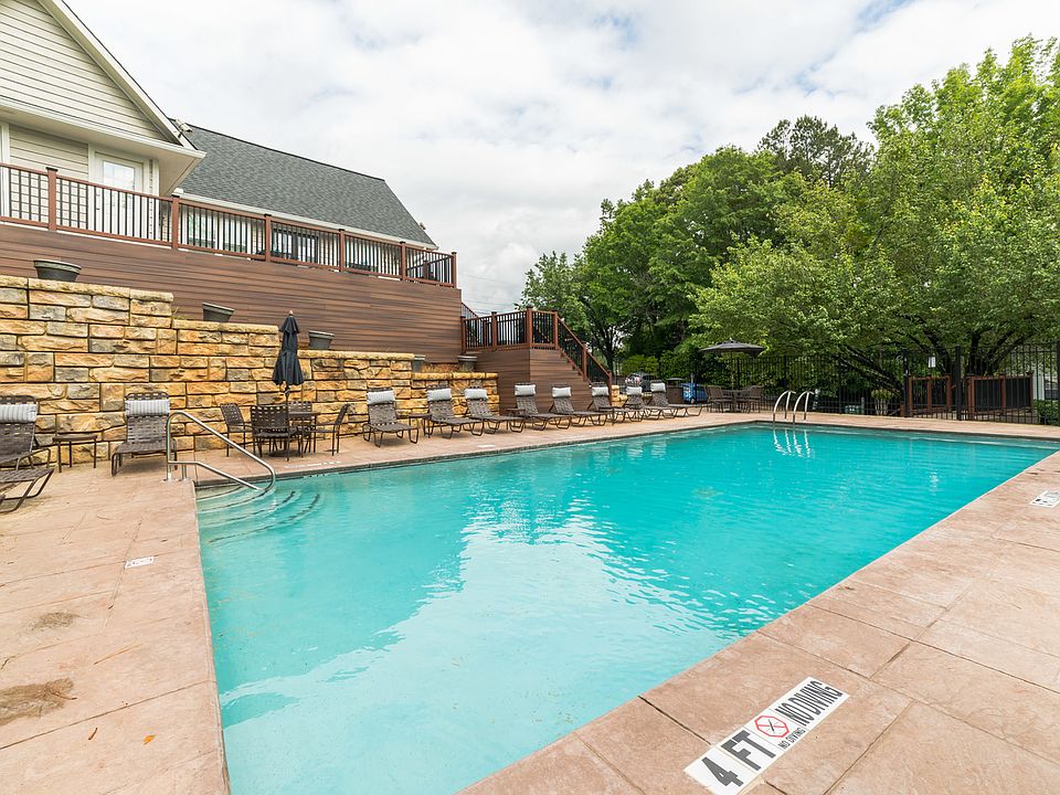 Sparkling pool with poolside lounge furniture and umbrellas