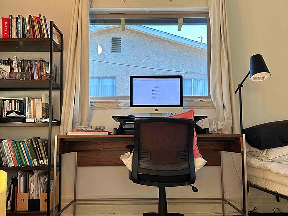 Room shown here with possible configuration for a bed, desk, armchair, and storage. Room is currently unfurnished.