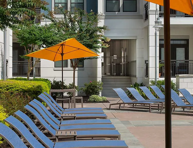 Lounge chairs with umbrellas by the pool