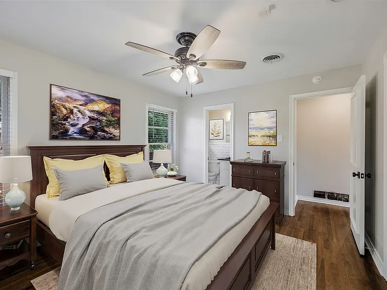 Virtually staged Master Bedroom featuring ceiling fan, dark hardwood / wood-style flooring, and ensuite bath