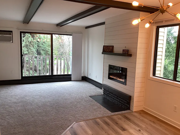 Living room with fireplace and deck access