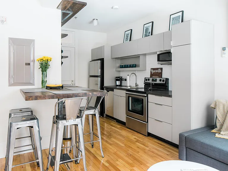 Updated kitchen with stainless steel appliances and custom built-ins