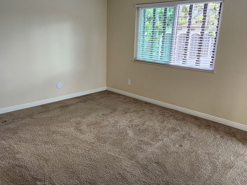 Master bedroom, with ceiling fan and sliding door to patio.