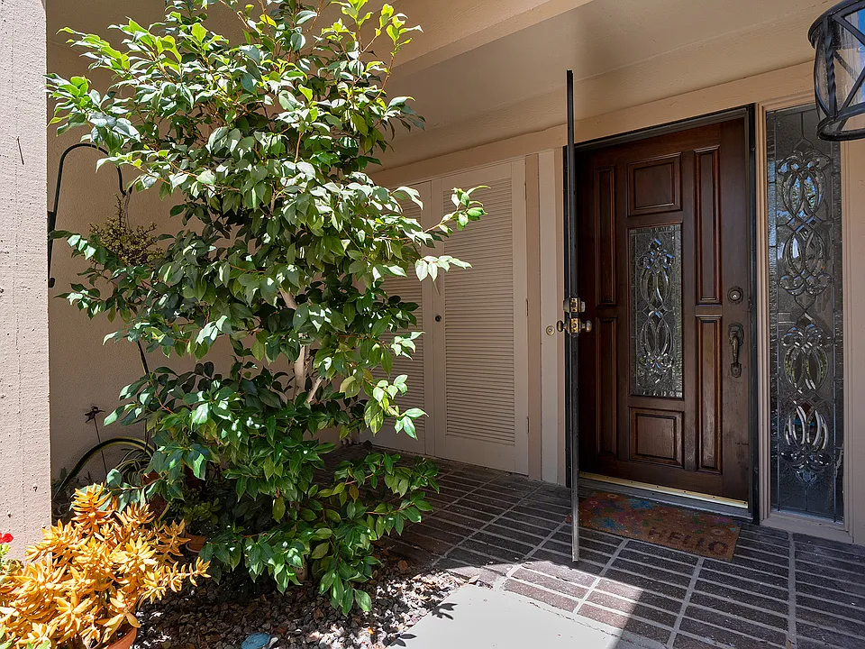 View of the front door, surrounded by succulents and prime vegetation, yet pleasantly shaded from direct sunlight throughout the day.