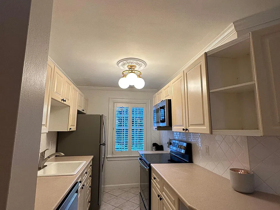 stunning white kitchen with plenty of storage and refreshed with Italian lighting
