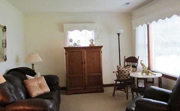 Living room with hardwoods under carpet