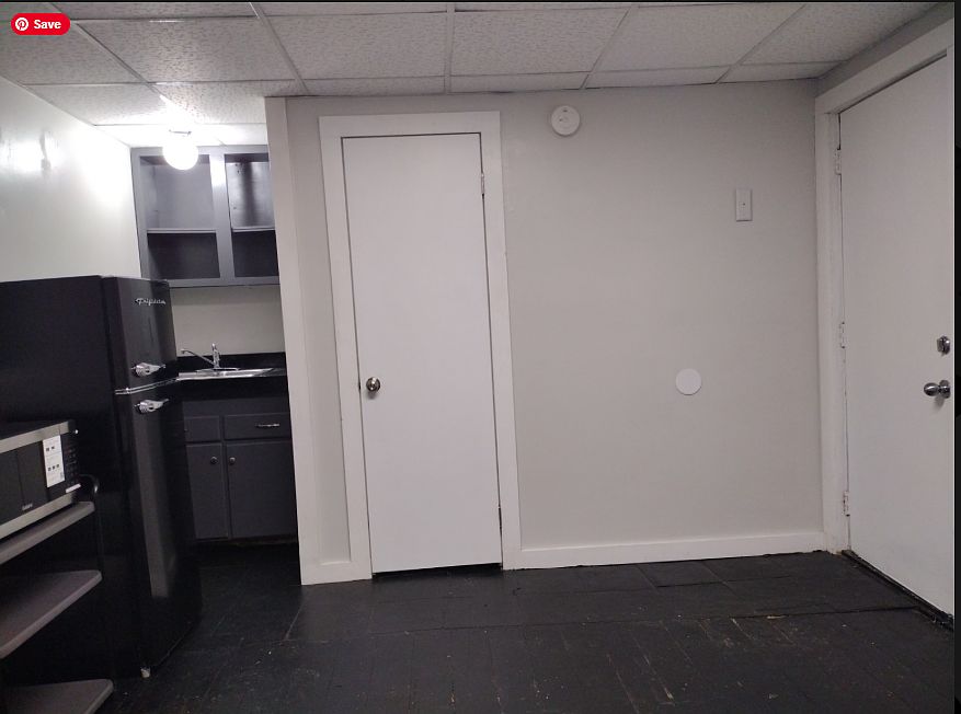 View from west wall to kitchen area, entry and bath