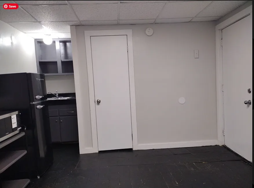 View from west wall to kitchen area, entry and bath
