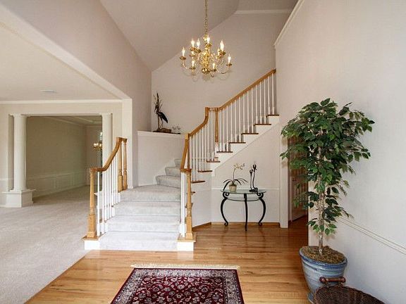 Dramatic two-story Foyer welcomes you with gleaming hardwood floors, and extensive millwork