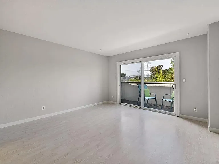 Large 3rd Bedroom facing private deck. Mirrored closet doors (4) along entire 16' wall. Very large 16' X 3' closet. Wired for Cable TV