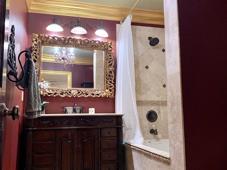 Bathroom w/large jacuzzi tub. The paint color has changed to a soft grey and white trim. Pictures will be updated soon.