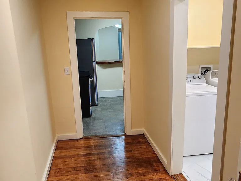 Hall from the 3rd bedroom to the 2nd bath, laundry, and kitchen.