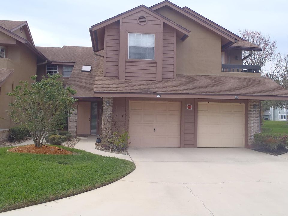 front, left garage with door to the left