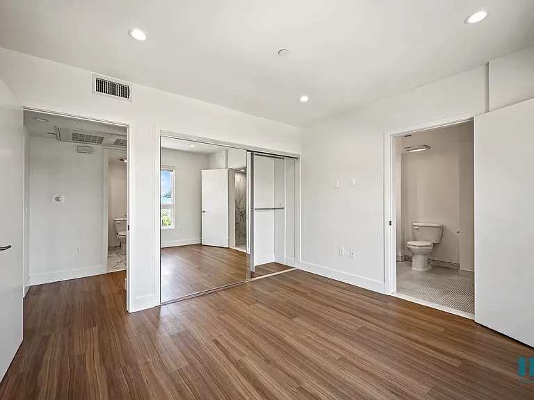 Bedroom with In-Suite Bathroom and Mirrored Closet