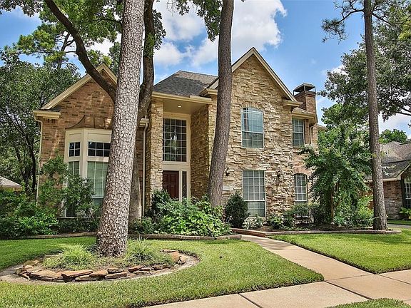 Mature trees and landscaping with sprinkler systems makes for an inviting front yard.