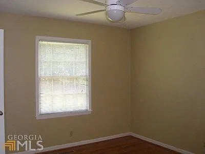 Bedroom #2 window to front yard, edge of door to bathroom and ceiling fan