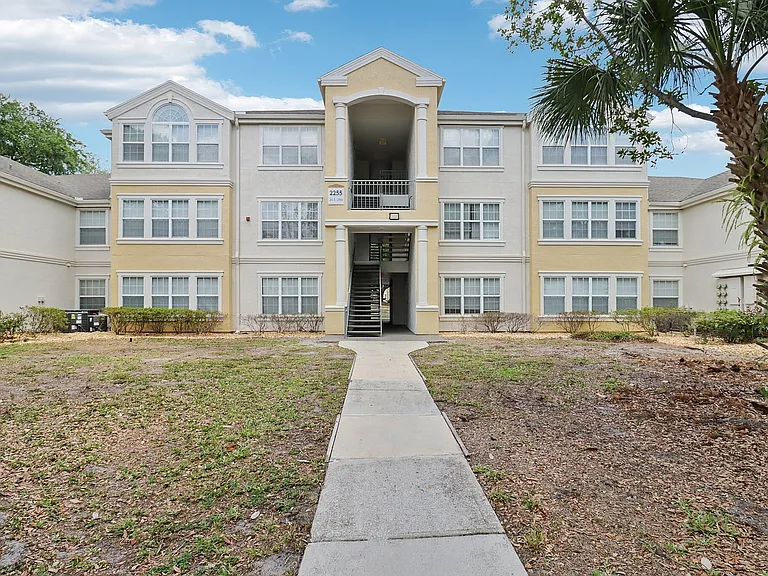Spacious apartment community with a welcoming entrance and open green surroundings