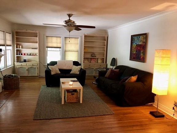 Living room with attached matching book shelves & ornamental fireplace.