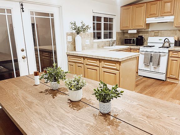 Large fully equipped kitchen with doors that open onto the patio. Views of the mountains and palm trees from the large dining room table.