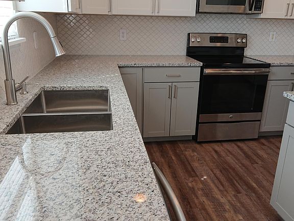 Extra deep, double square basin undermount sink. New faucet with in-counter soap dispenser.