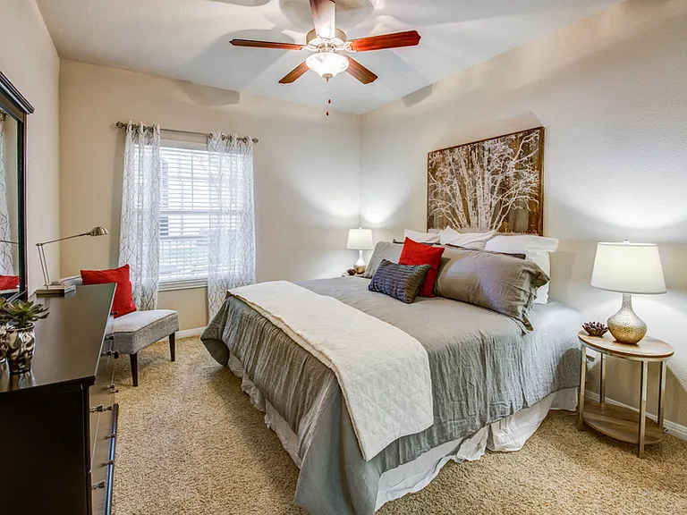 Spacious carpeted bedrooms with ceiling fan and natural light