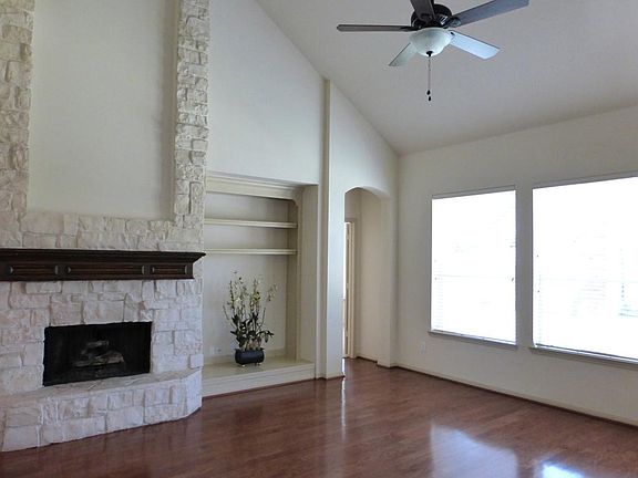 The Den Has Great Windows to View the Backyard Area and A Gas Log Fireplace