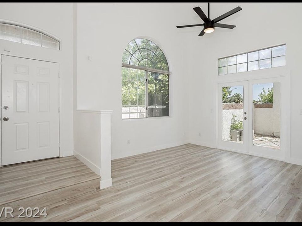 entryway, living room with fireplace and backyard access