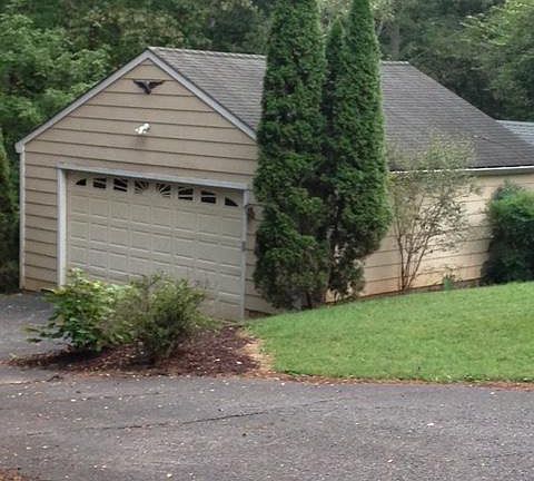 Detached 2 car garage with storage shed behind it