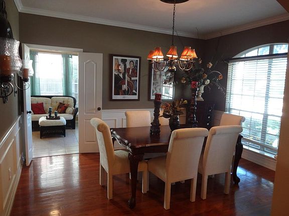 Formal dining room with chair railing and crown molding