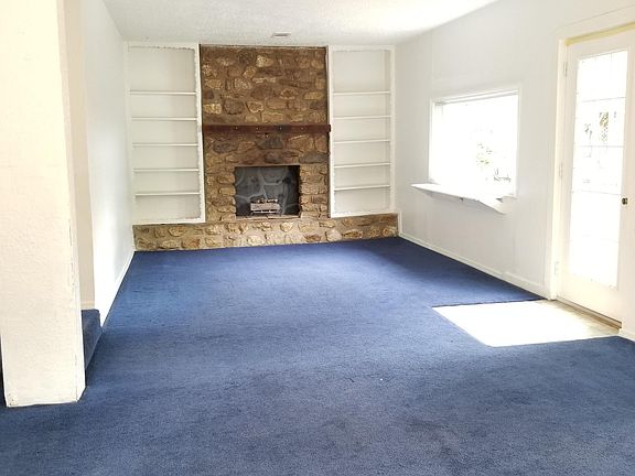 Living room with decorative fireplace and shelves