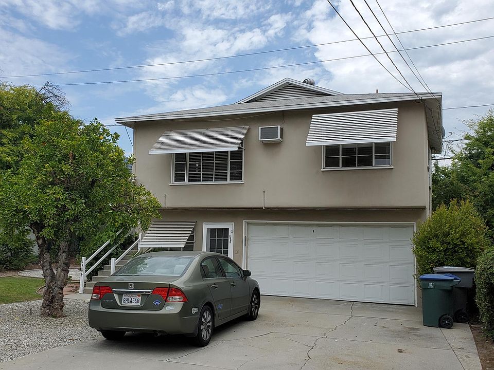 Front of unit on second floor with garage. Separate studio unit located on first floor.