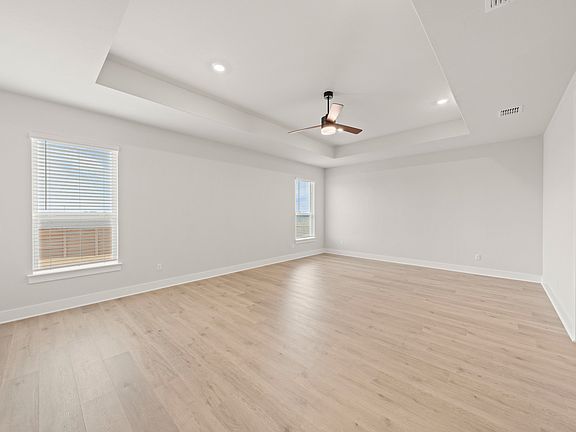 The master bedroom is spacious and has two large windows that let in great, natural light.